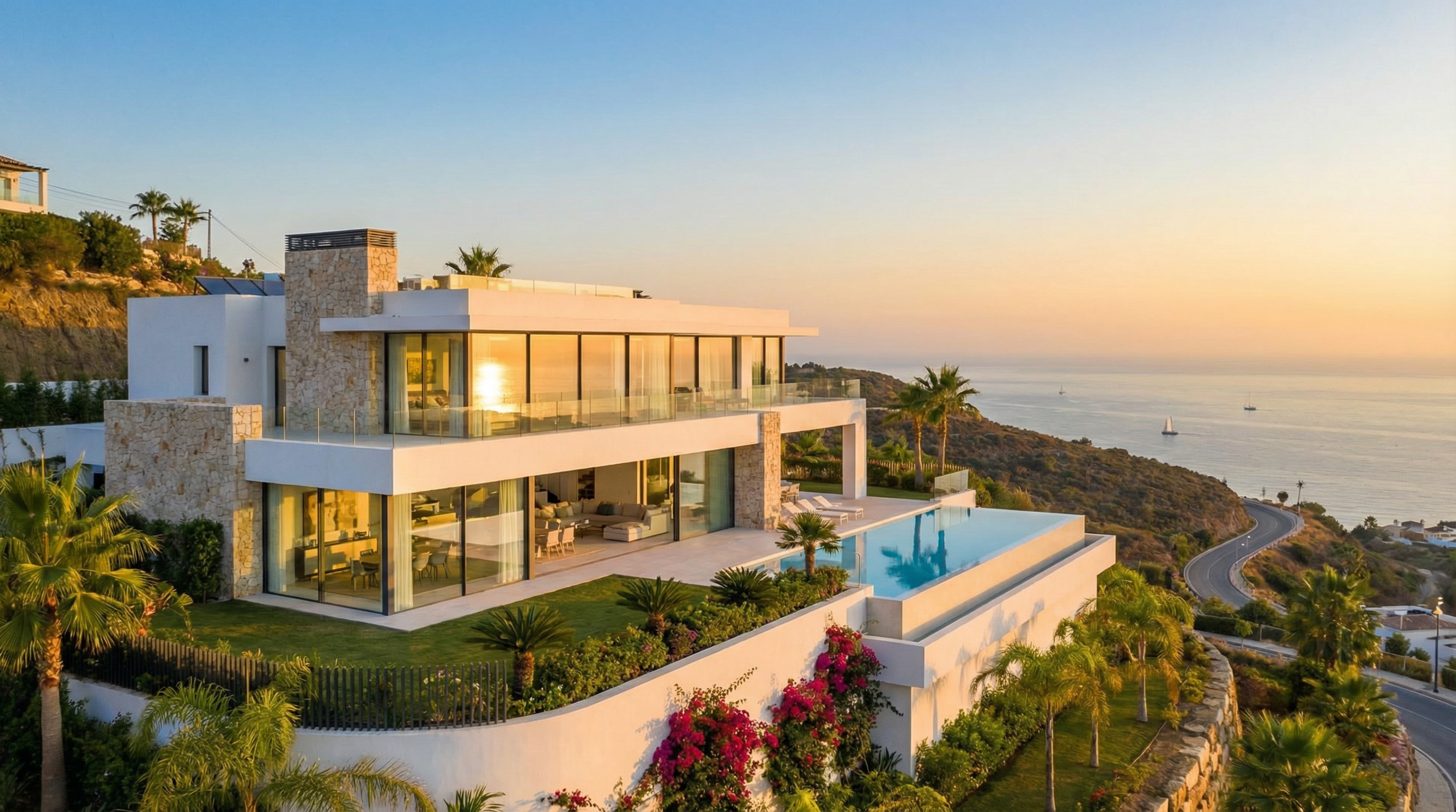 Luxurious villa in Costa del Sol showcasing stunning architecture and Mediterranean views, surrounded by lush greenery during golden hour.