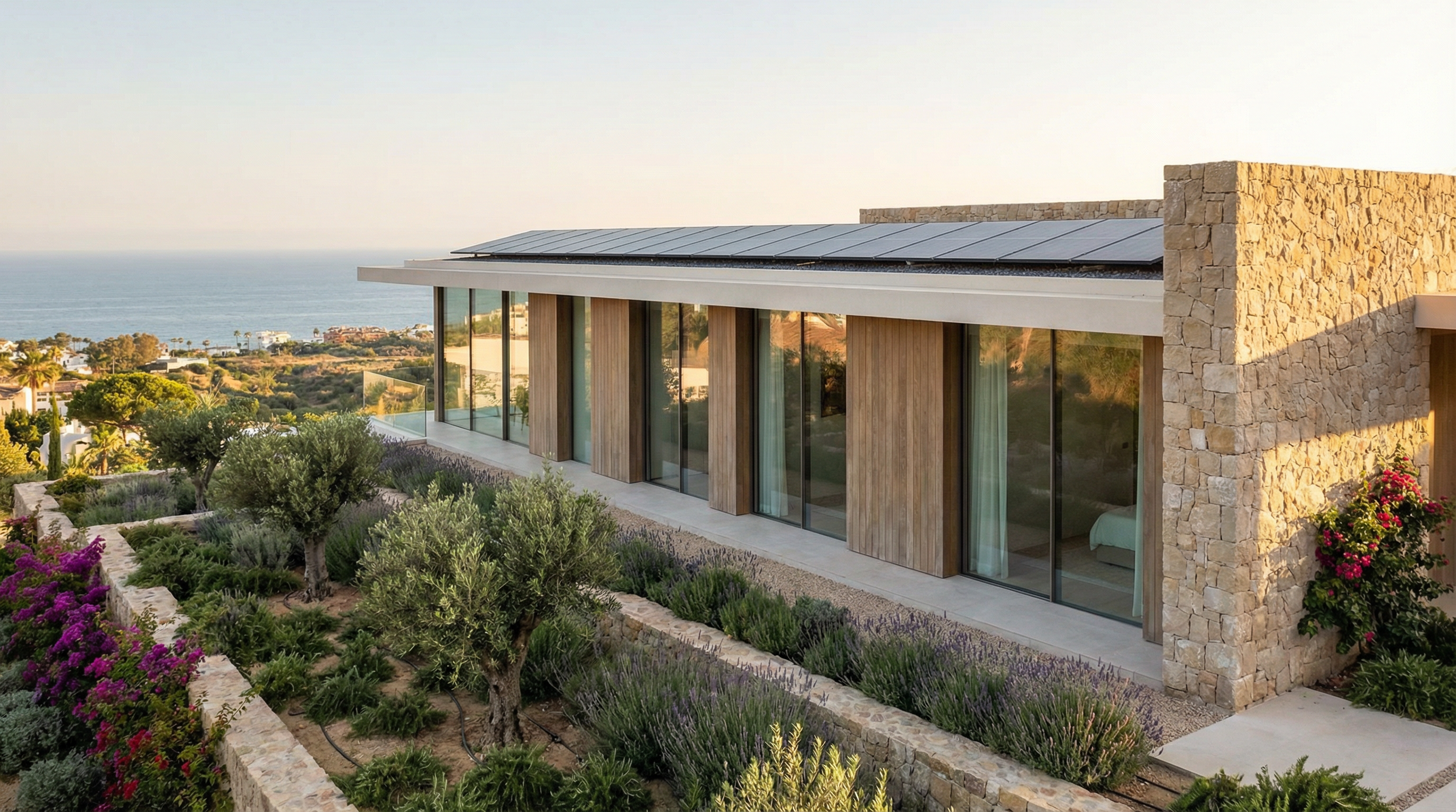A modern energy-efficient home in Costa del Sol, featuring solar panels, large windows, and lush Mediterranean landscaping, set against a vibrant coastline.