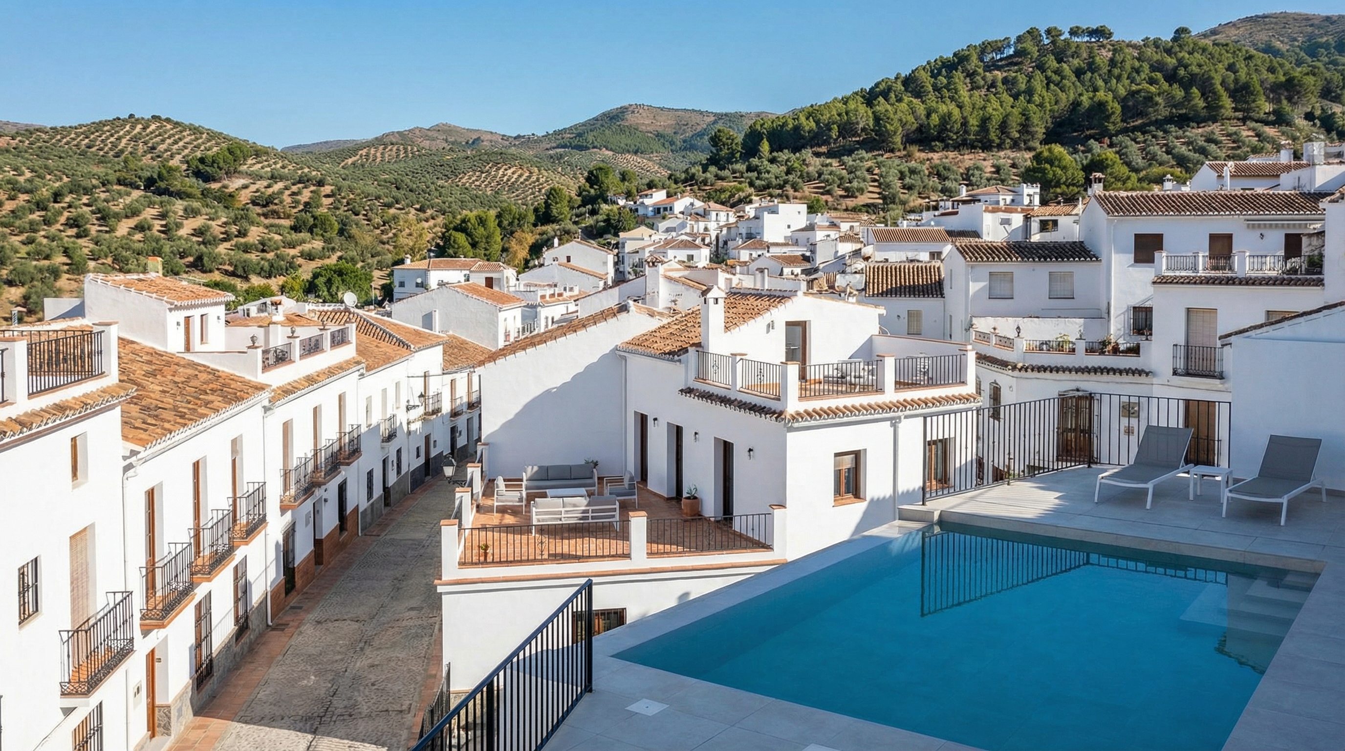 Aerial view of Monda, Costa del Sol showing Mediterranean coastline, luxury properties, and cost of property opportunities